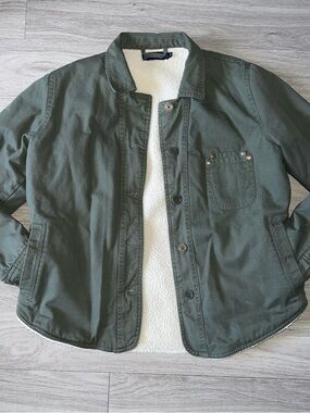 United By Blue green jacket with white sherpa lining and blue tag